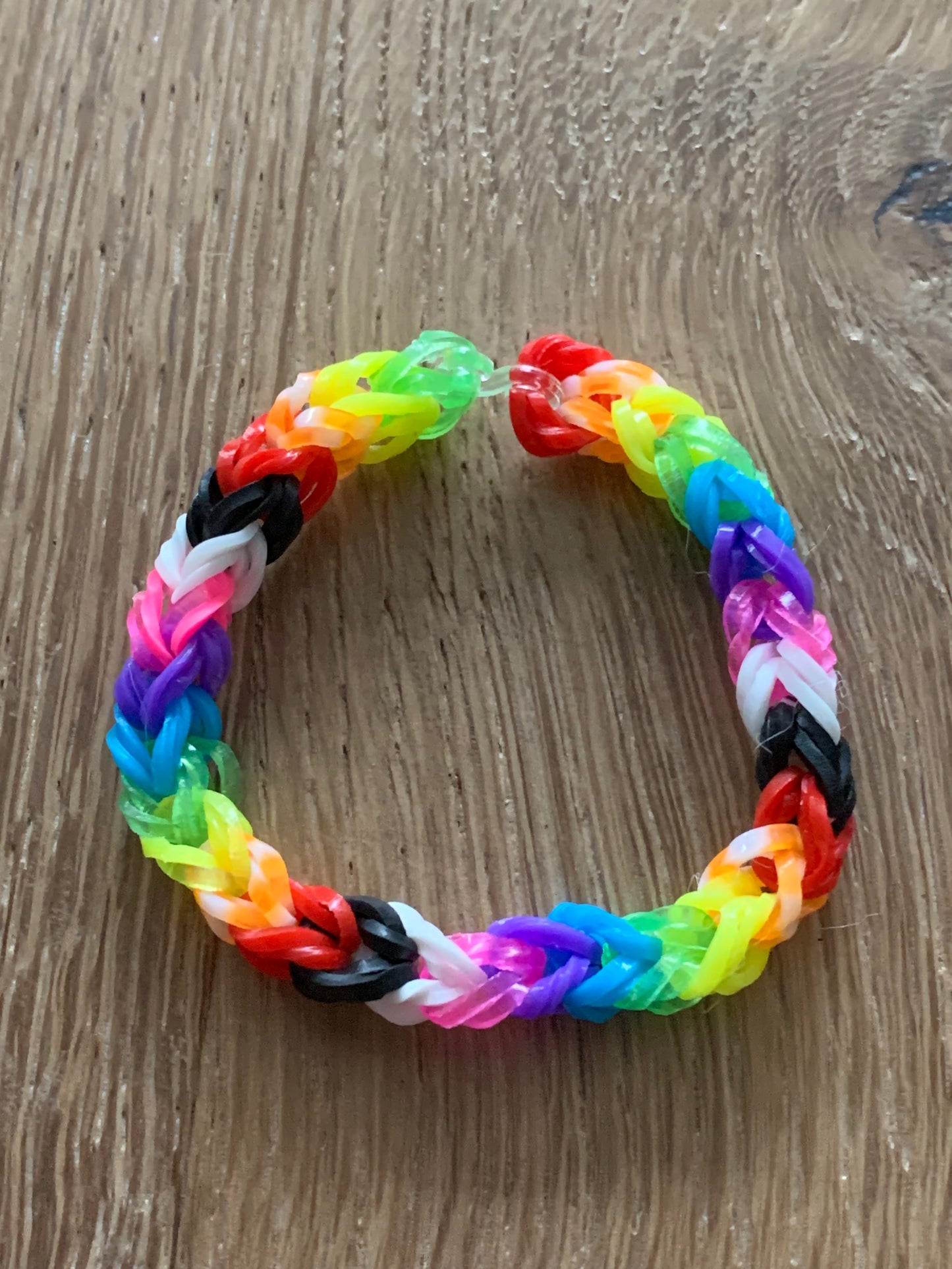 Loom band rainbow bracelet with a little black and white